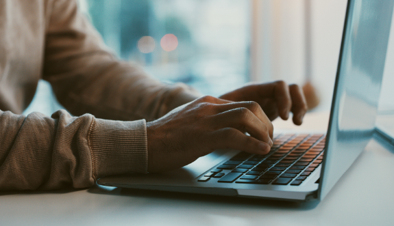 Typing Blog on Laptop